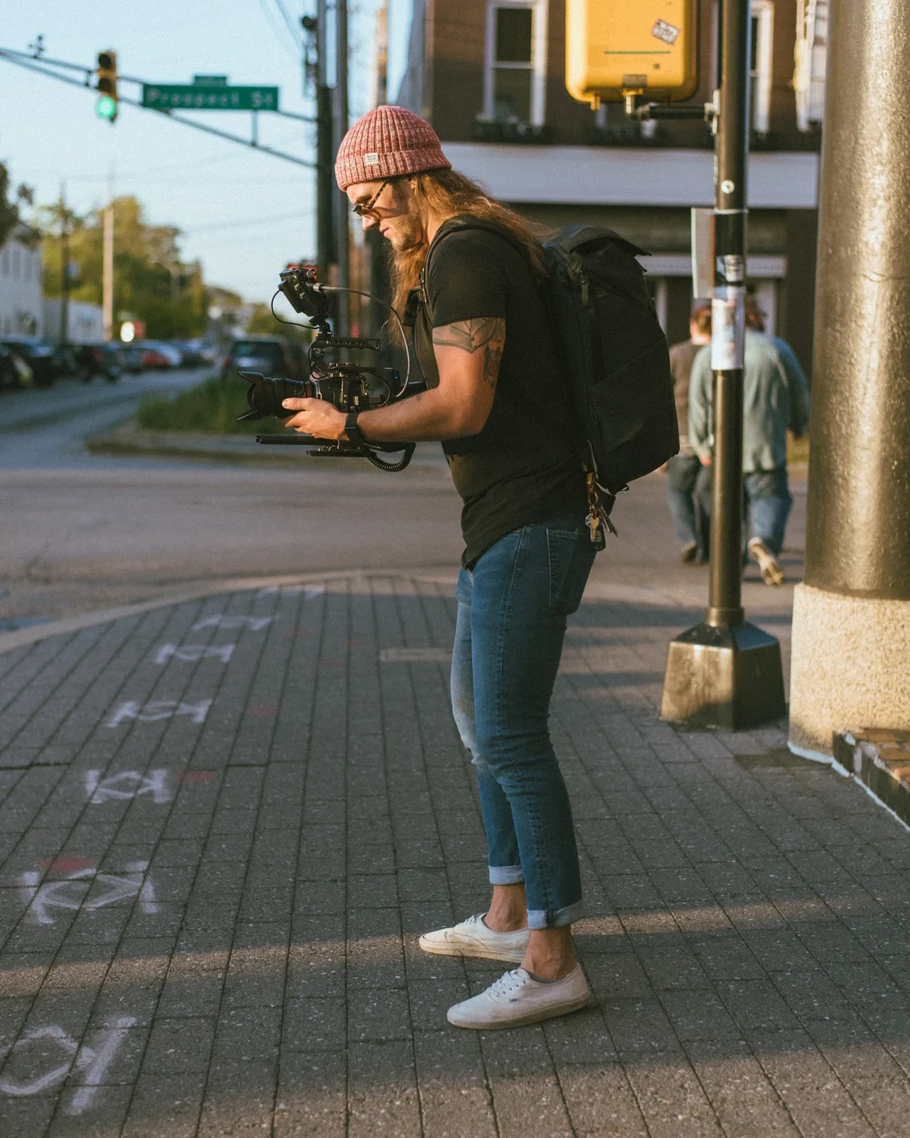 Kyle Williams walking to a shoot with camera in hand